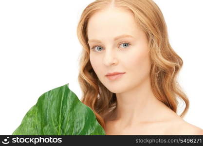 picture of woman with green leaf over white