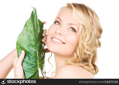 picture of woman with green leaf over white