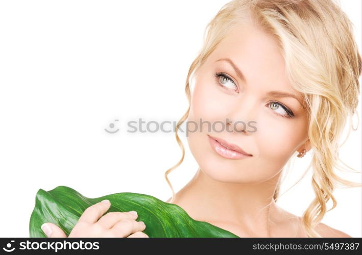 picture of woman with green leaf over white