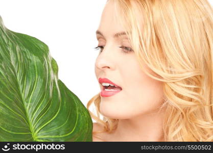 picture of woman with green leaf over white