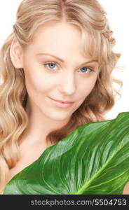 picture of woman with green leaf over white