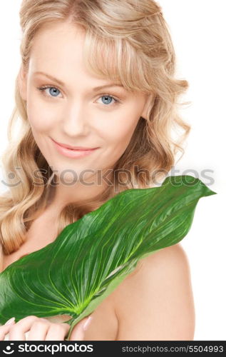 picture of woman with green leaf over white