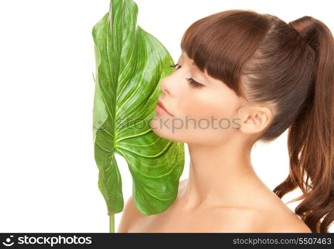 picture of woman with green leaf over white