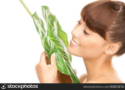 picture of woman with green leaf over white