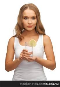 picture of woman with lemon slice on glass of water .