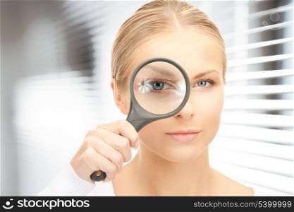 picture of woman with magnifying glass in office