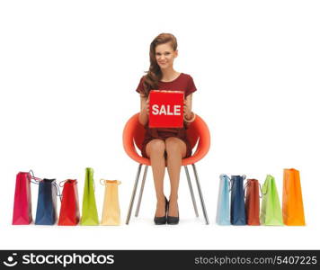 picture of woman with shopping bags and sale sign .