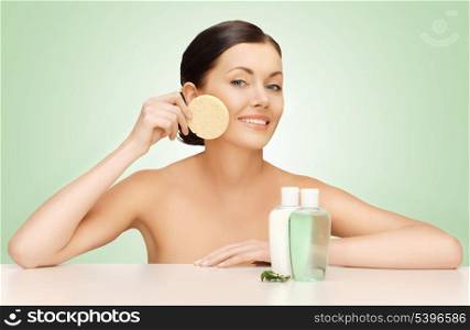 picture of woman with sponge and cosmetic bottles
