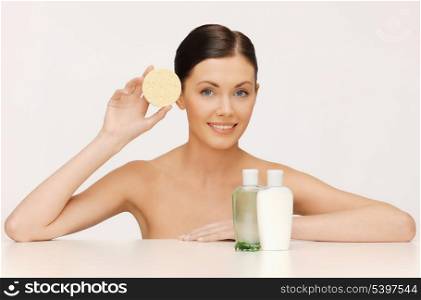 picture of woman with sponge and cosmetic bottles