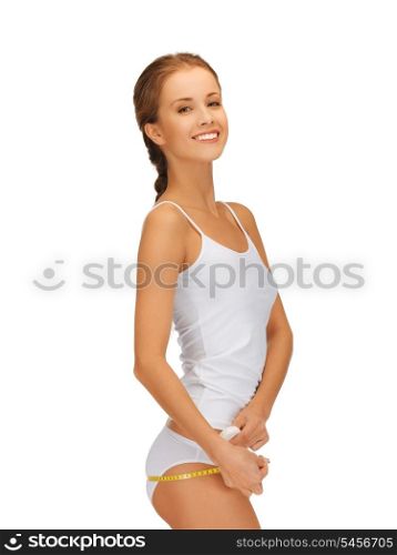 picture of young beautiful woman measuring her hips