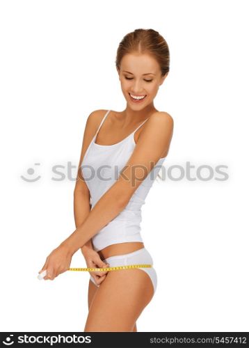 picture of young beautiful woman measuring her hips