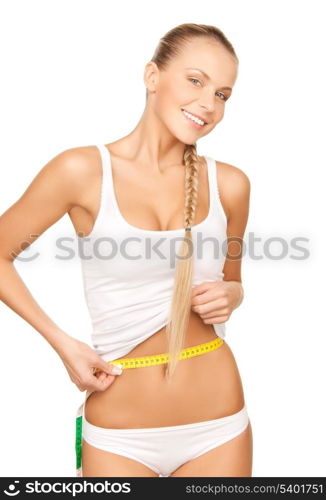 picture of young beautiful woman measuring her waist