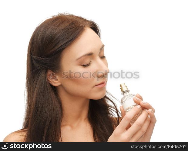 picture of young beautiful woman smelling perfume
