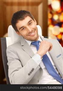 picture of young businessman sitting in chair