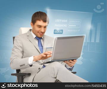 picture of young businessman sitting in chair with laptop