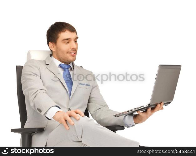 picture of young businessman sitting in chair with laptop