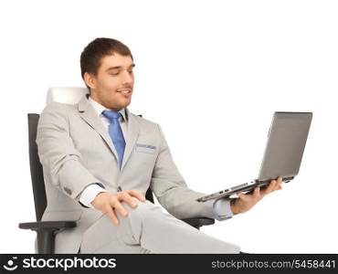 picture of young businessman sitting in chair with laptop