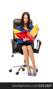 picture of young businesswoman with folders sitting in chair