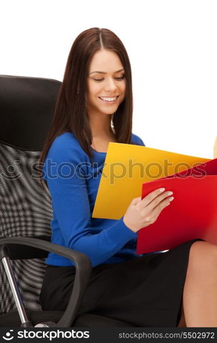 picture of young businesswoman with folders sitting in chair