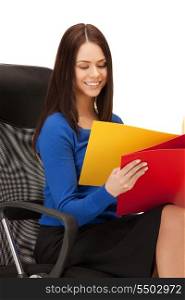 picture of young businesswoman with folders sitting in chair
