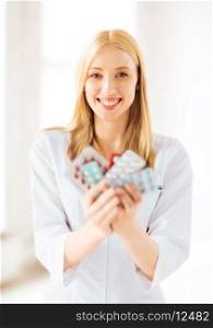 picture of young female doctor with pack of pills
