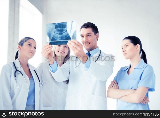 picture of young group of doctors looking at x-ray. young group of doctors looking at x-ray