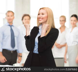 picture of young happy woman with hands up in office