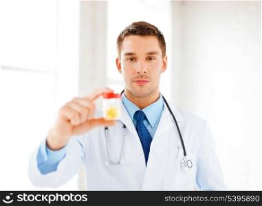 picture of young male doctor with jar of capsules