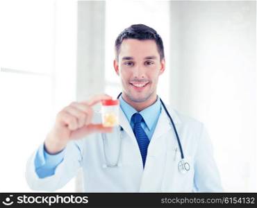 picture of young male doctor with jar of capsules. male doctor with jar of capsules