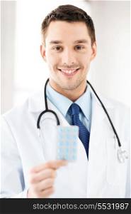 picture of young male doctor with pack of pills