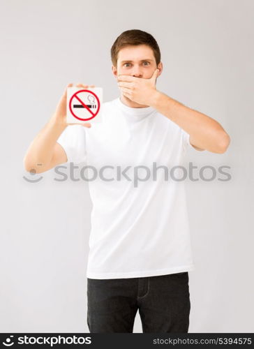 picture of young man holding no smoking sign