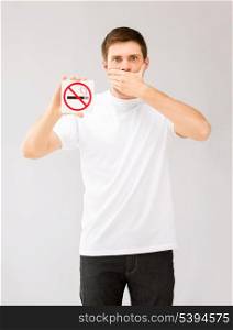 picture of young man holding no smoking sign