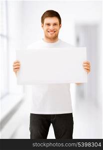 picture of young man holding white blank board