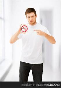 picture of young man pointing at no smoking sign