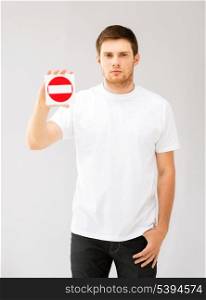 picture of young man showing no entry sign .