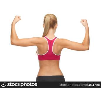 picture of young sporty woman showing her biceps