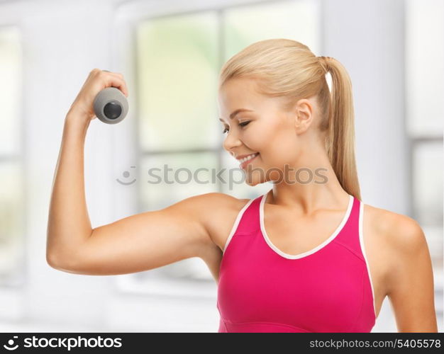 picture of young sporty woman with light dumbbell