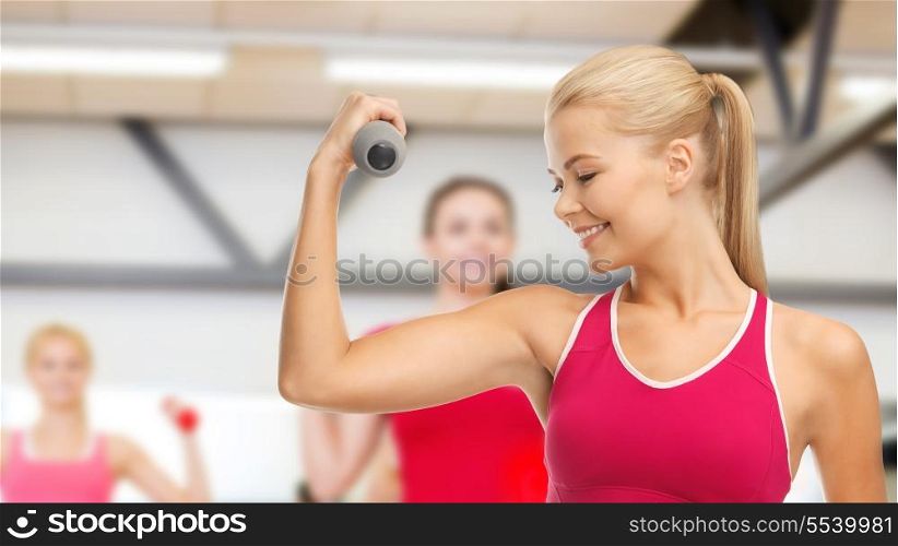 picture of young sporty woman with light dumbbell