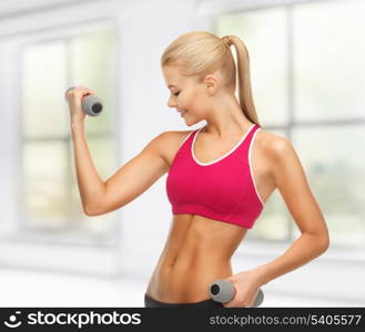 picture of young sporty woman with light dumbbells