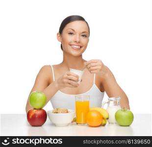 picture of young woman eating healthy breakfast. young woman eating healthy breakfast