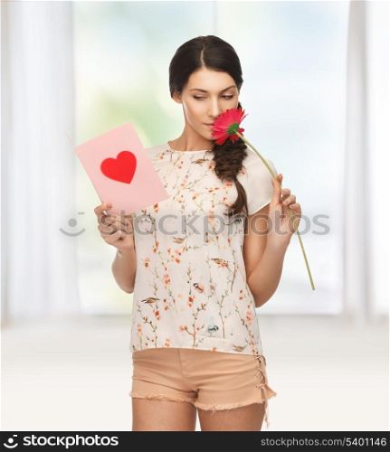 picture of young woman holding flower and postcard.
