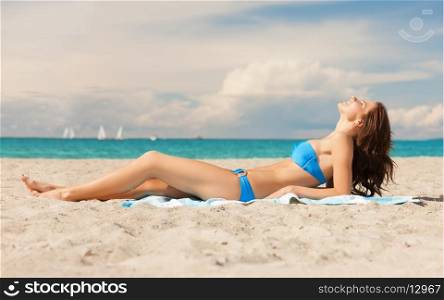 picture of young woman lying on the beach.