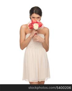 picture of young woman smelling bouquet of flowers.