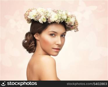 picture of young woman wearing wreath of flowers .
