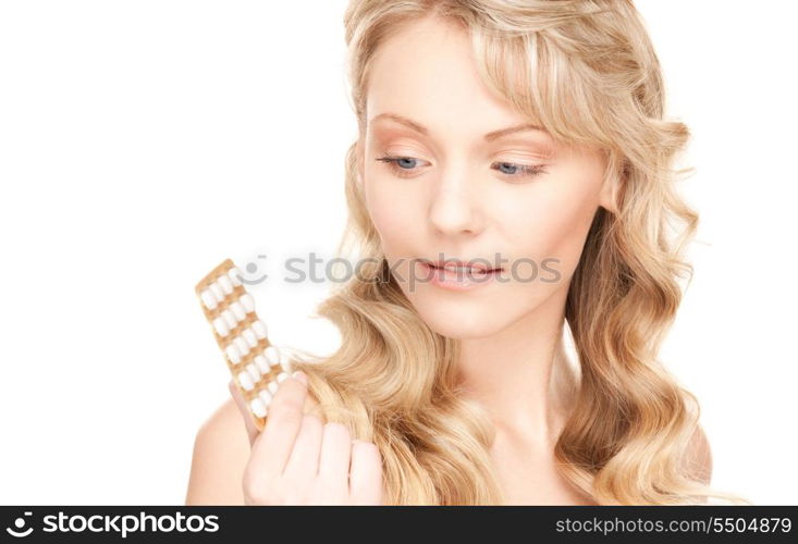 picture of young woman with pills over white