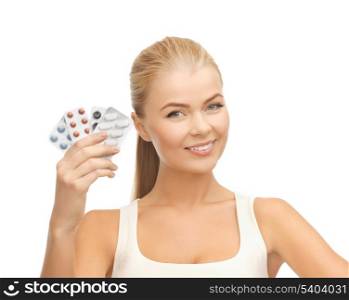 picture of young woman with variety of pills