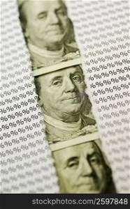 Pictures of Benjamin Franklin and percentage signs on paper