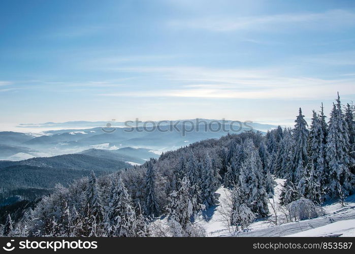 Picturesque and scenic panorama of winter mountains on a sunny day on the blue sky background with copy space.