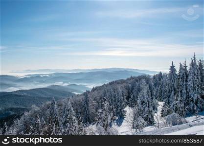 Picturesque and scenic panorama of winter mountains on a sunny day on the blue sky background with copy space.