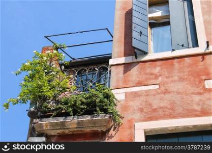 Picturesque balcony with flowers in an old Italian house